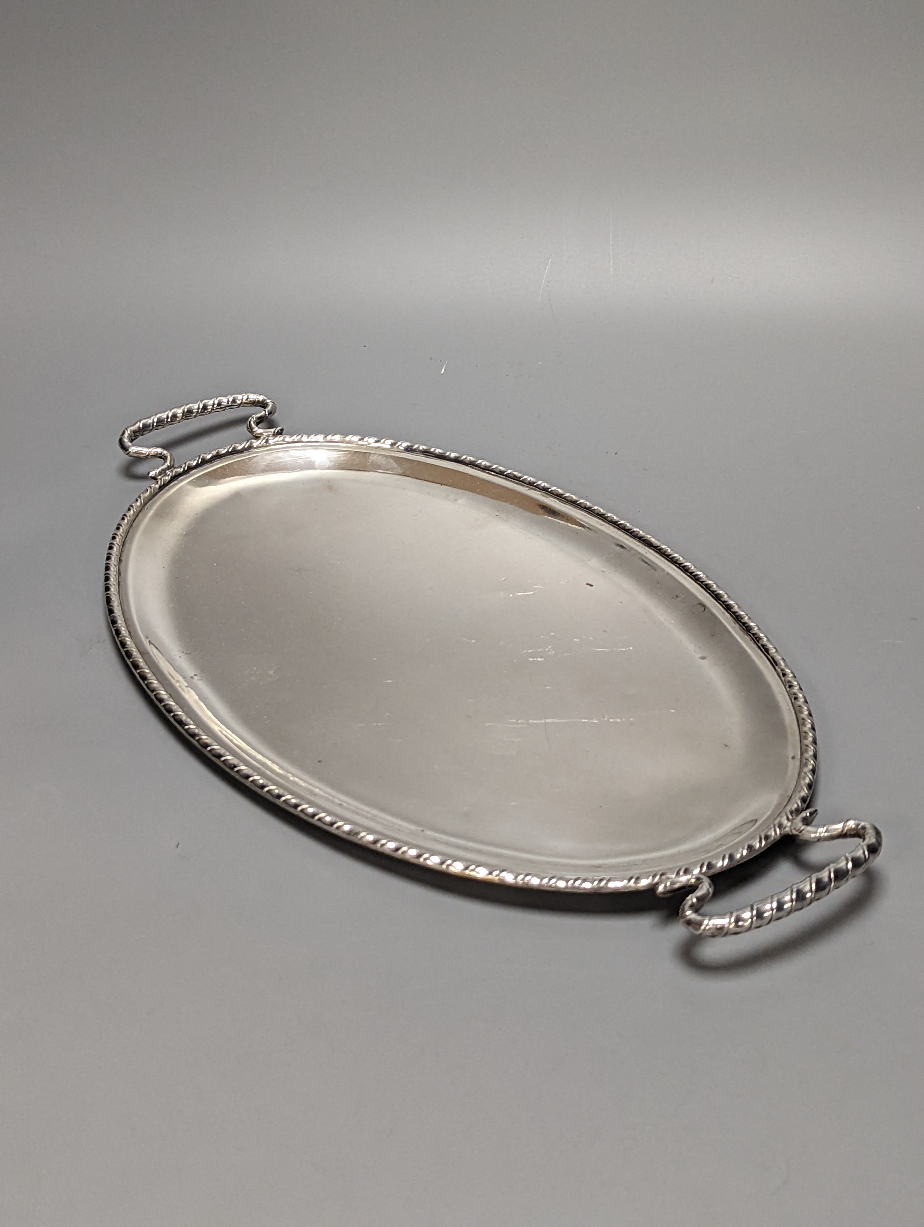 A Persian? white metal oval gallery tray, 45.7cm and an Italian 800 standard two handled oval tea tray